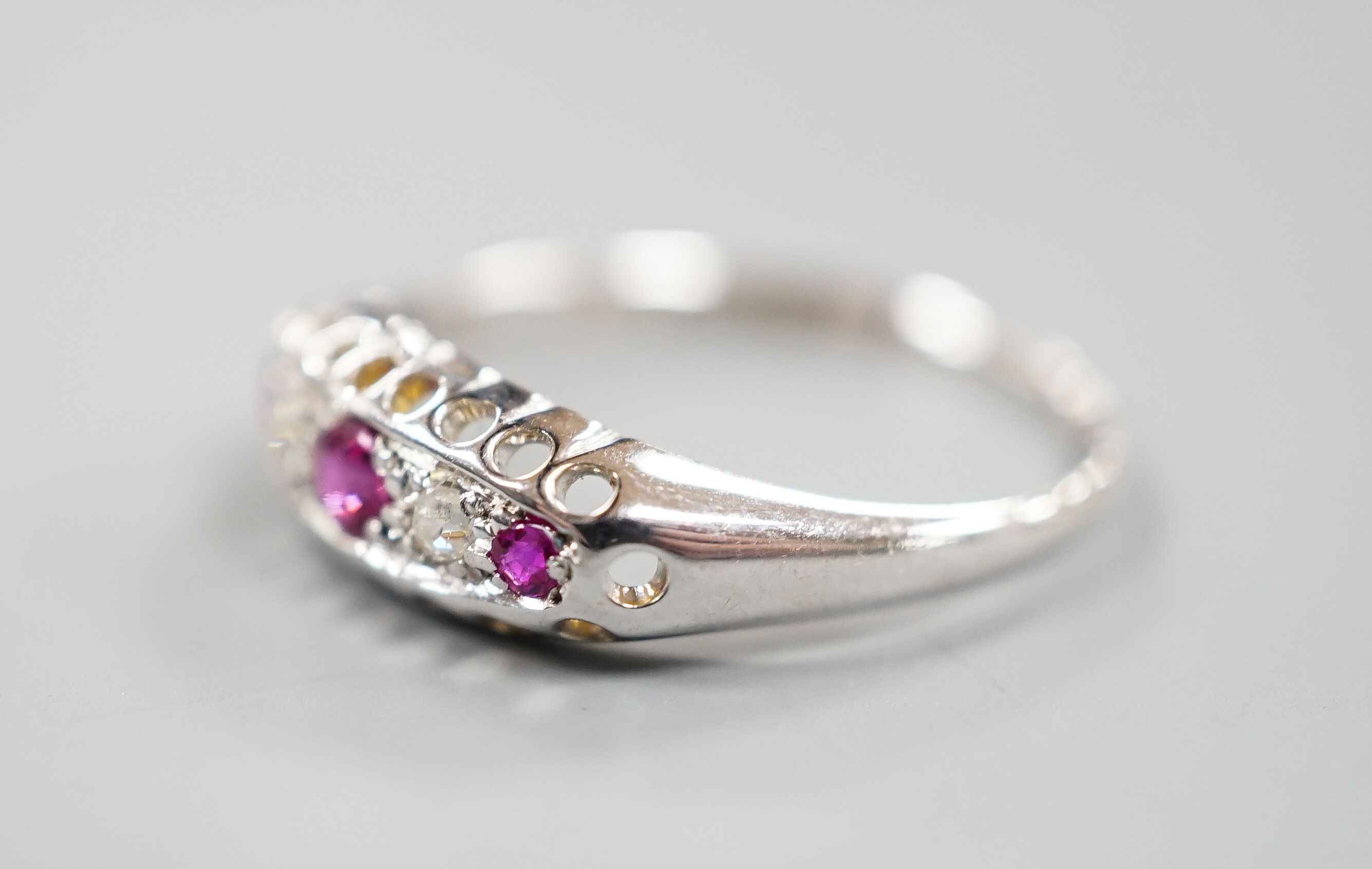 A George V 18ct white gold three stone ruby and two stone diamond ring, size P/Q, gross weight 2.3 grams.